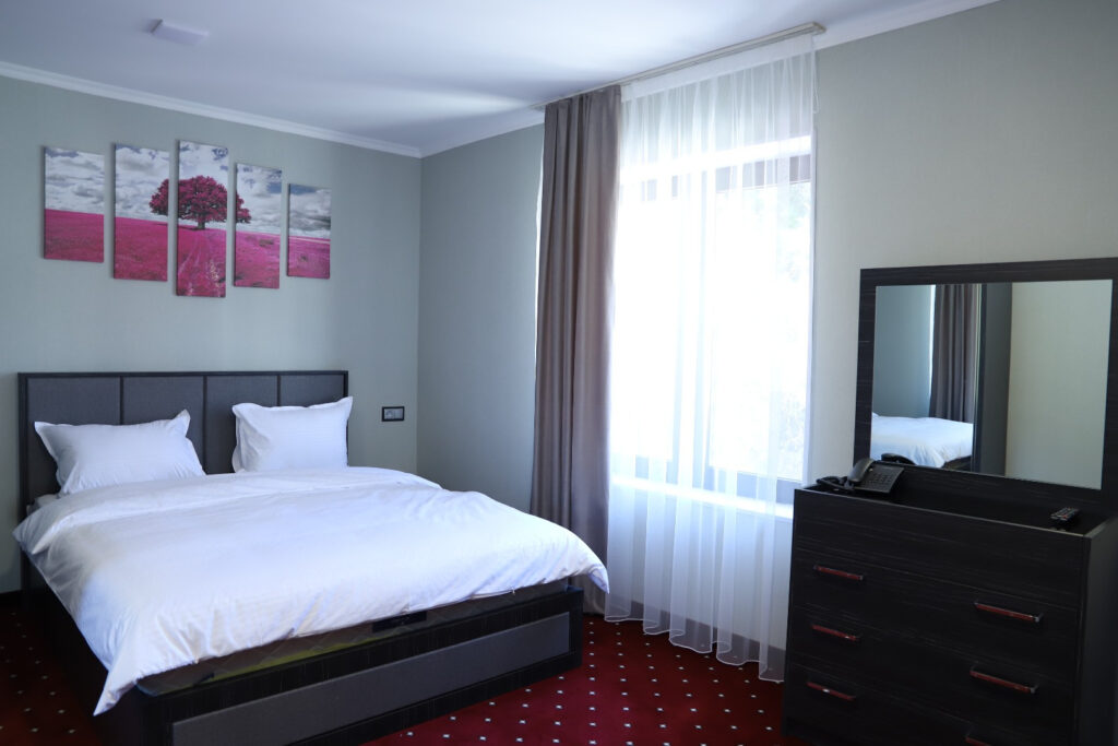 Double bed and window in a ThreeWays hotel room