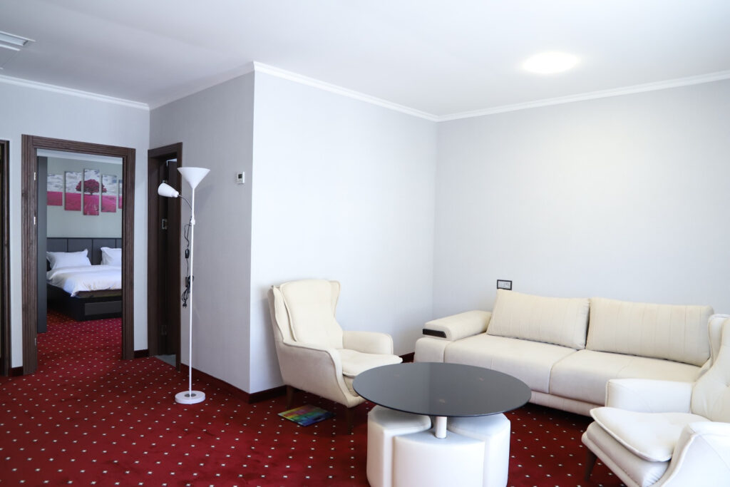 Sofa and armchairs in a ThreeWays hotel room