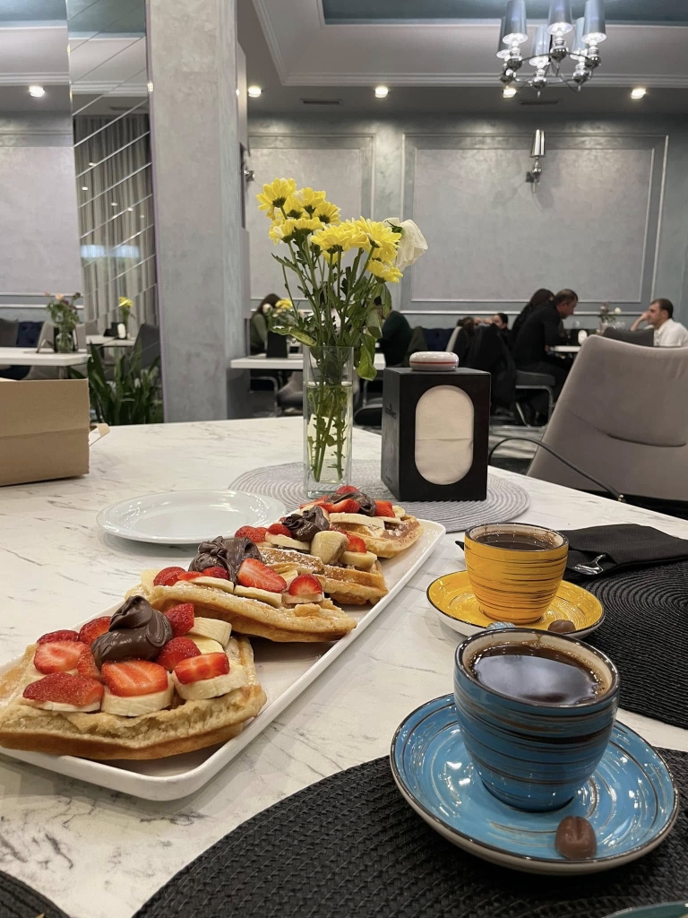 Waffles with strawberries and coffee at ThreeWays